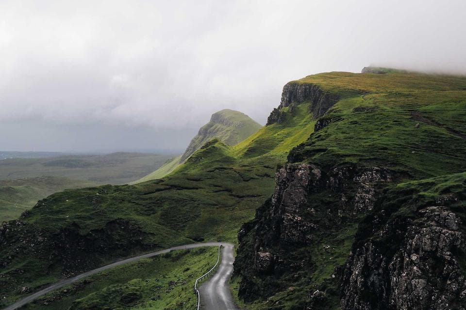 Green mountain ridge with a winding road